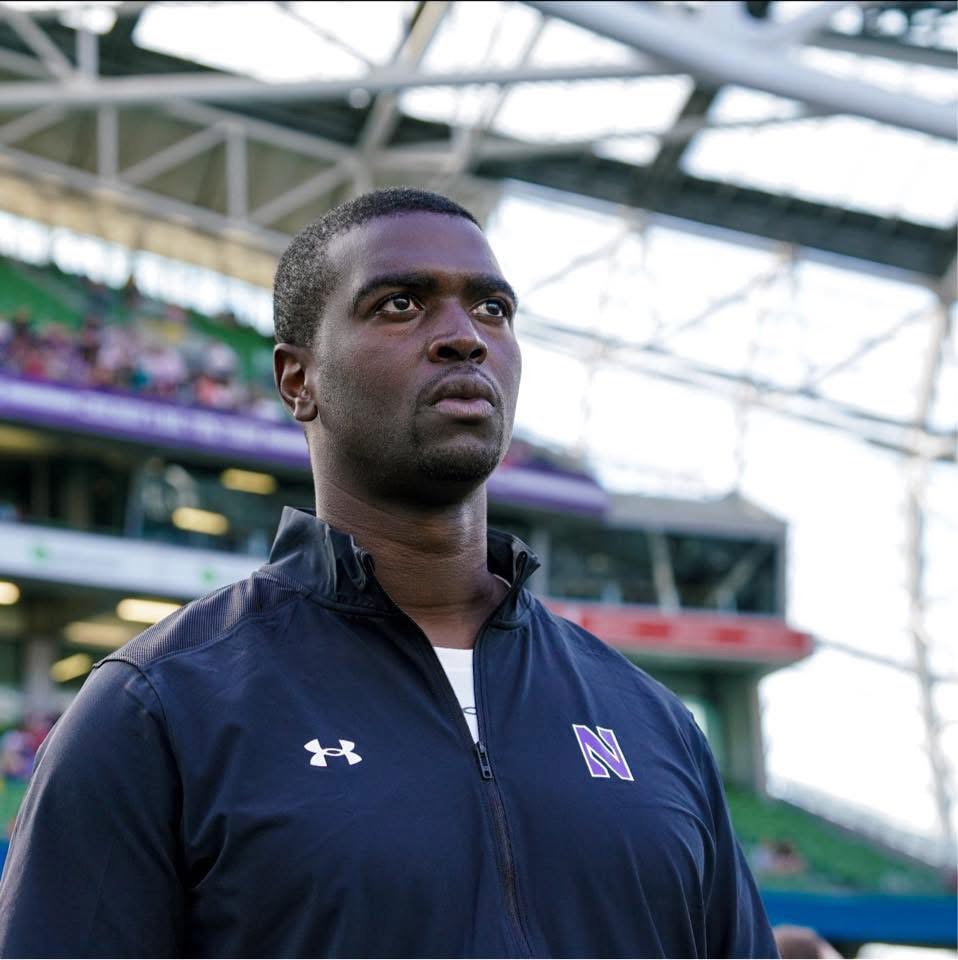 Julian Tucker on the field in Northwestern coaching apparel